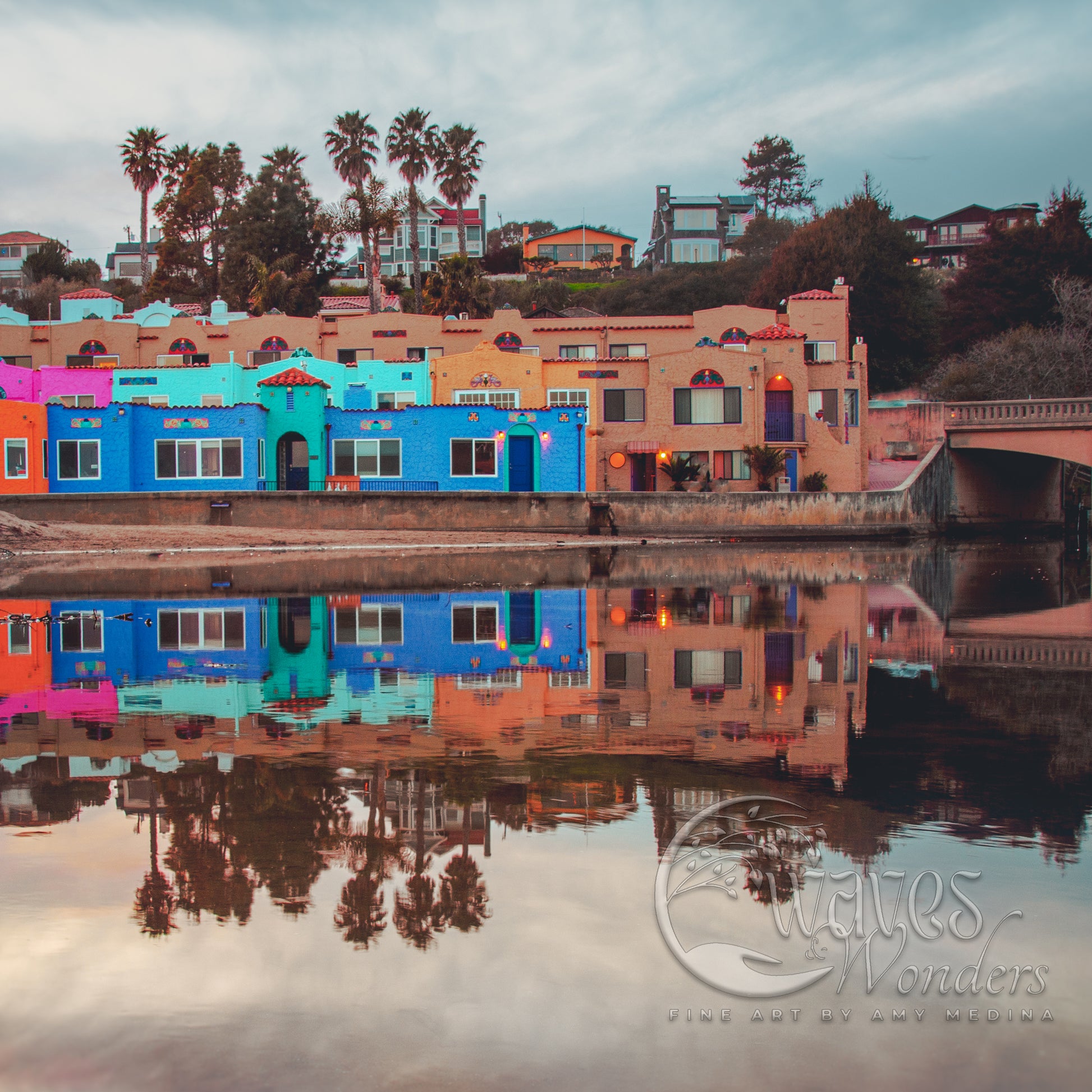 a row of colorful buildings next to a body of water