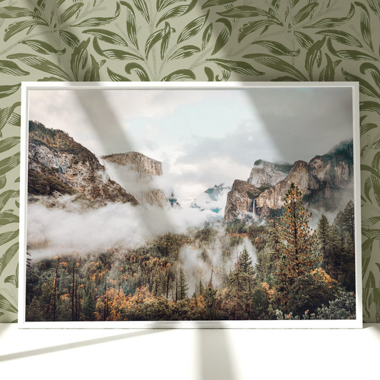 a picture of a mountain range in a frame on a wall