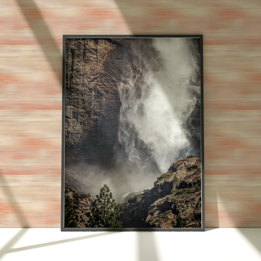 a picture hanging on a brick wall of a waterfall