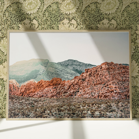 a picture of a mountain in a frame on a wall