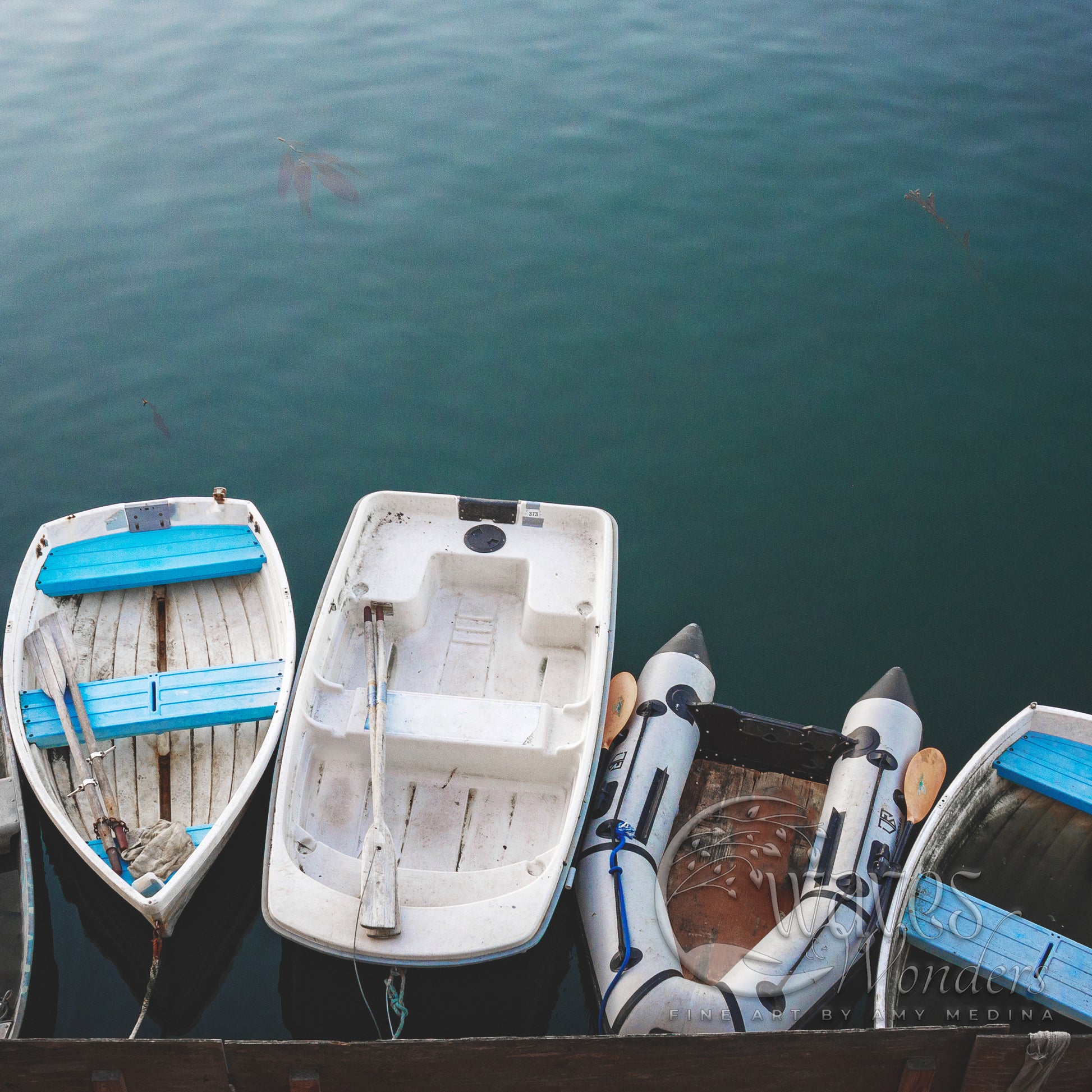 a row of small boats tied to a dock