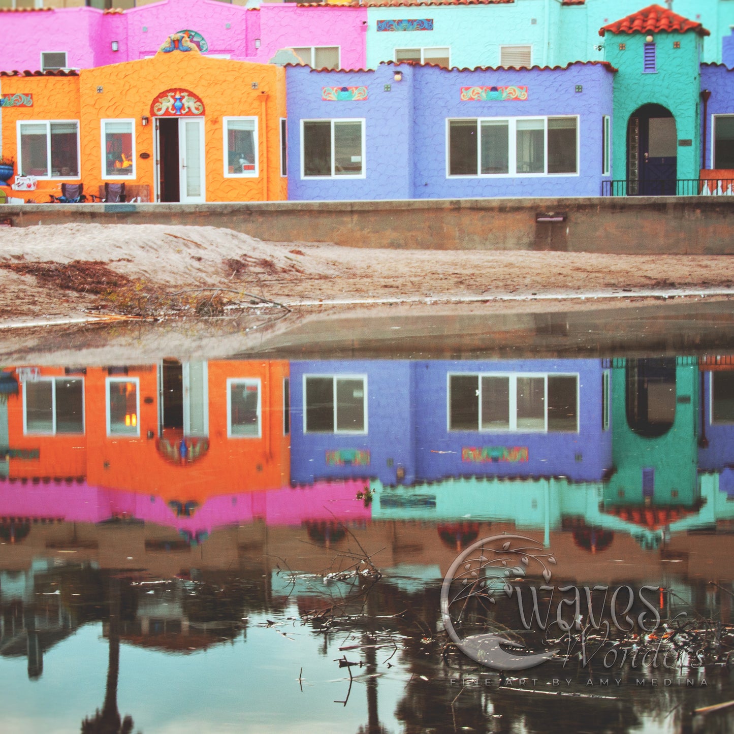 a reflection of a colorful building in a body of water