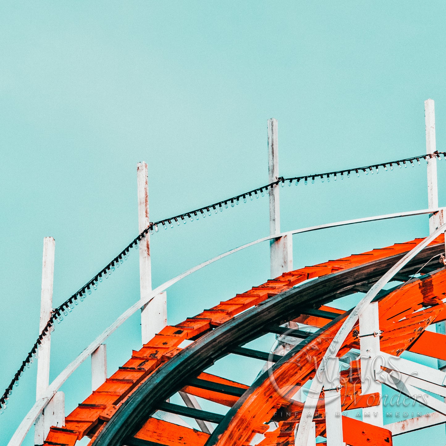 a close up of a roller coaster against a blue sky