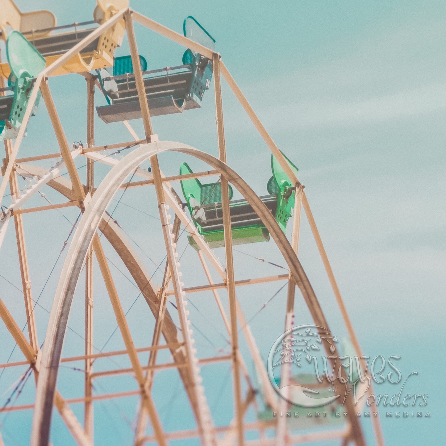 a ferris wheel with green seats on a cloudy day