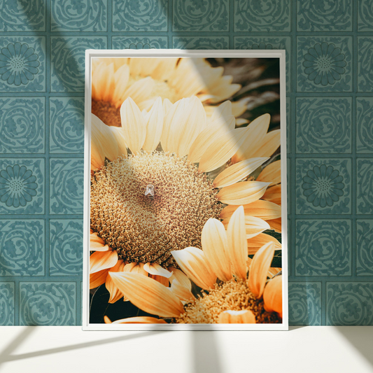 a picture of a sunflower in a frame on a wall