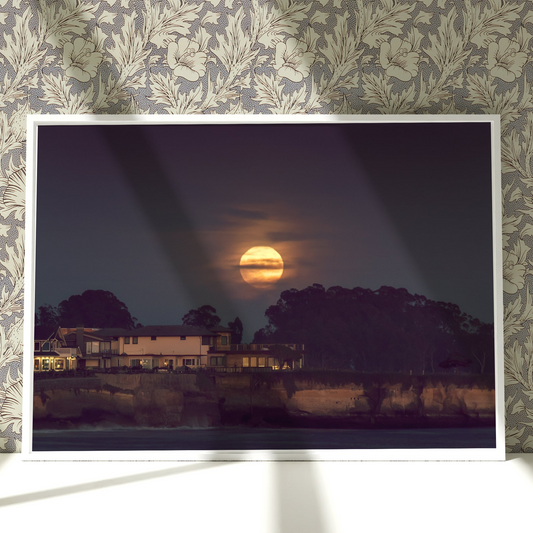 a picture of a full moon seen through a window