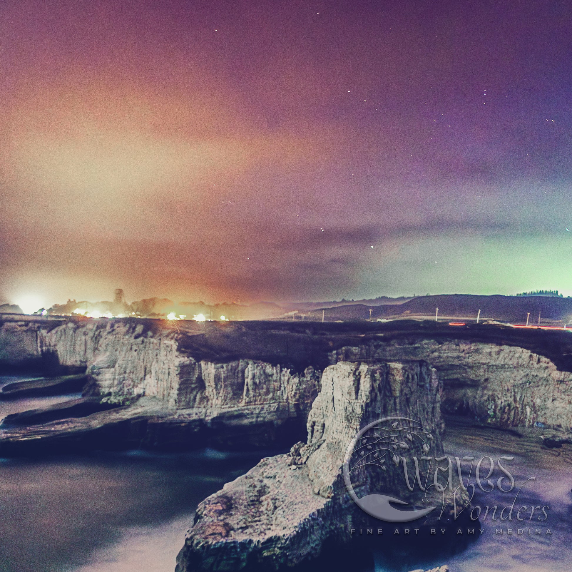 a view of a rocky cliff with a body of water in the foreground