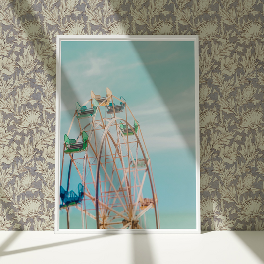 a ferris wheel in front of a wallpapered wall