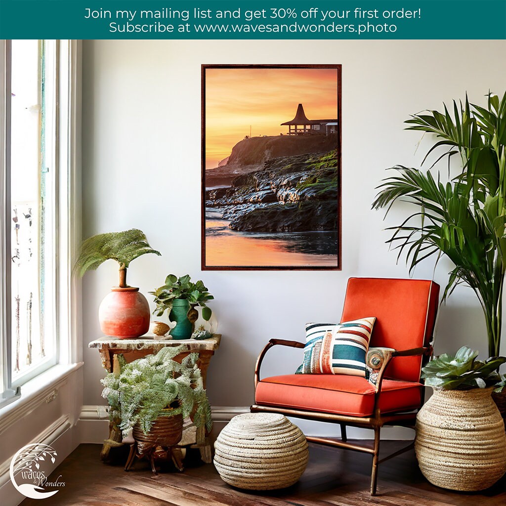 a living room with a chair and potted plants