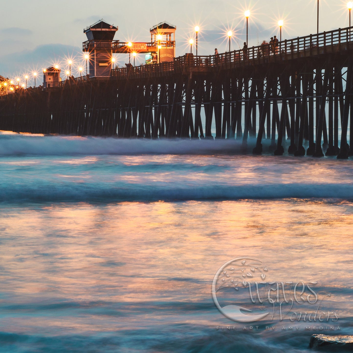 a long pier with lights on at night