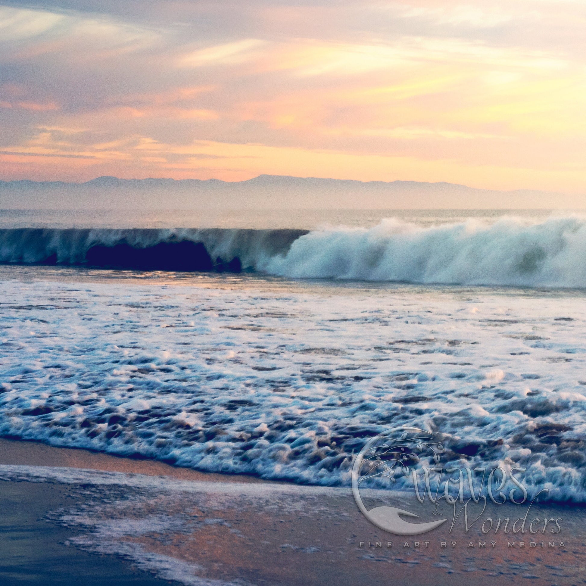 a wave rolls in on the beach as the sun sets