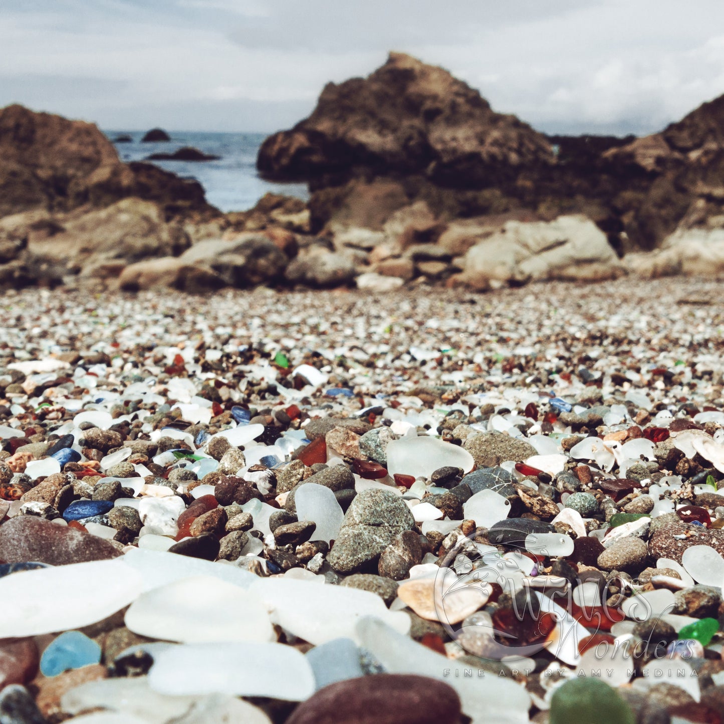 a beach covered in lots of glass and rocks