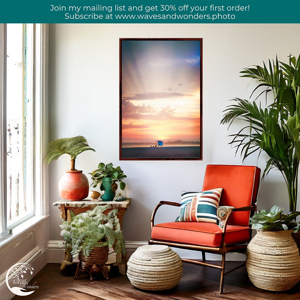 a room with a chair, potted plants, and a picture on the wall