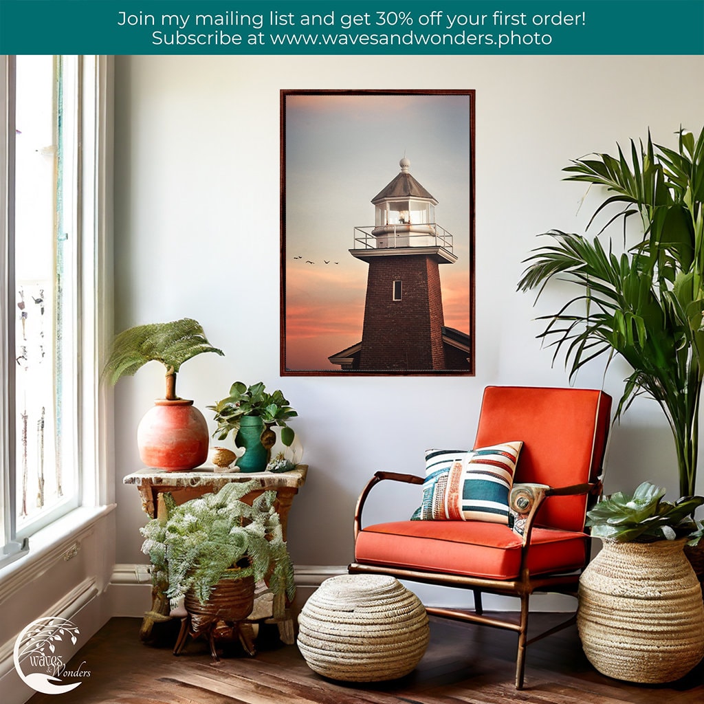 a living room with a chair, potted plants and a picture of a lighthouse