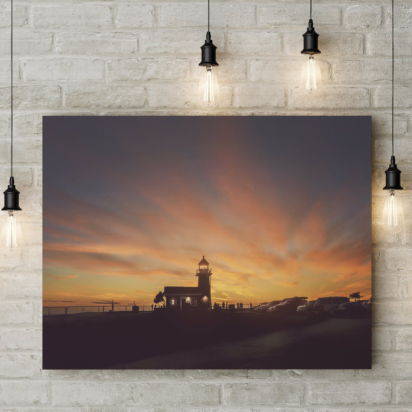 a picture hanging on a brick wall of a lighthouse