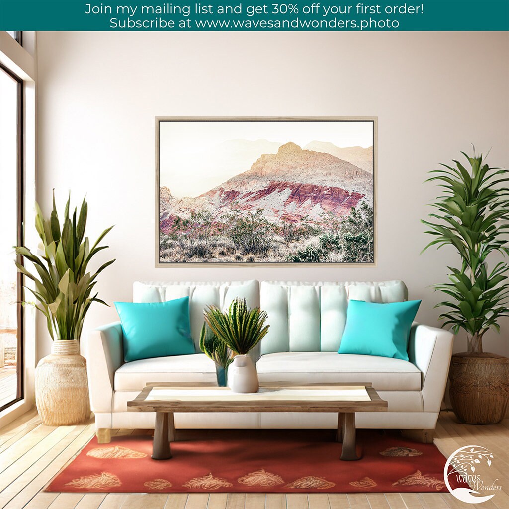 a living room with a couch, table and potted plants