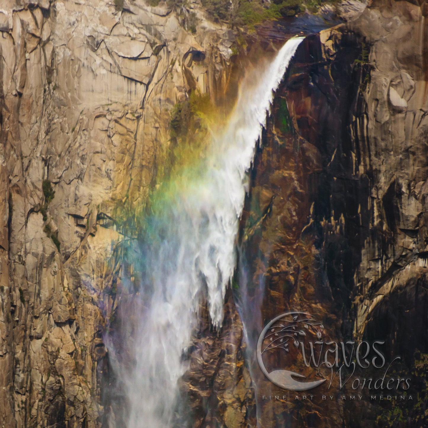 a waterfall with a rainbow in the middle of it