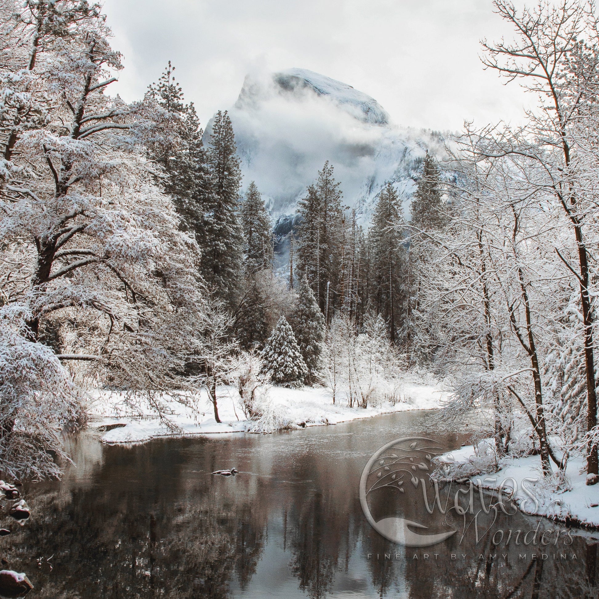 a mountain covered in snow next to a river