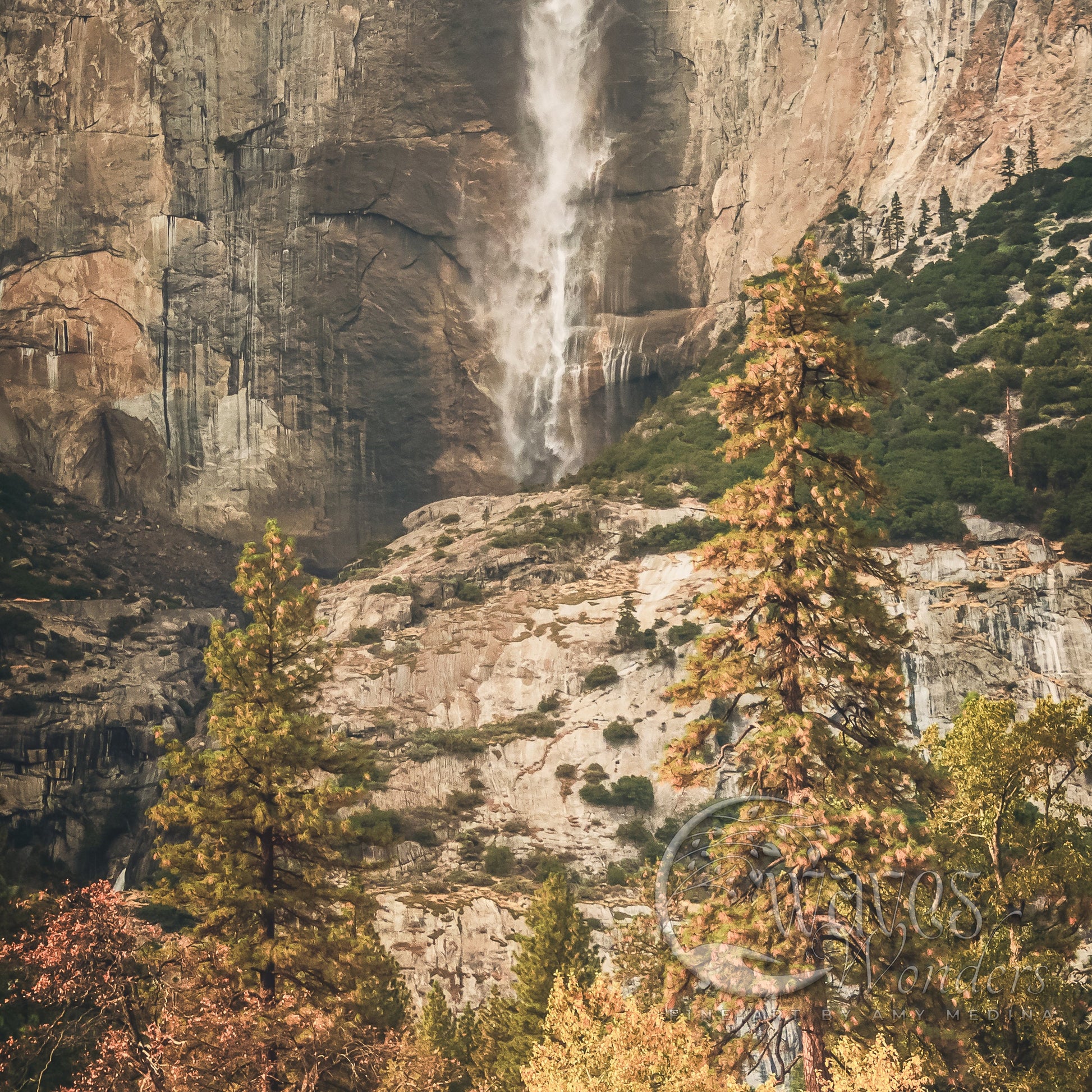 a large waterfall is coming down a mountain side