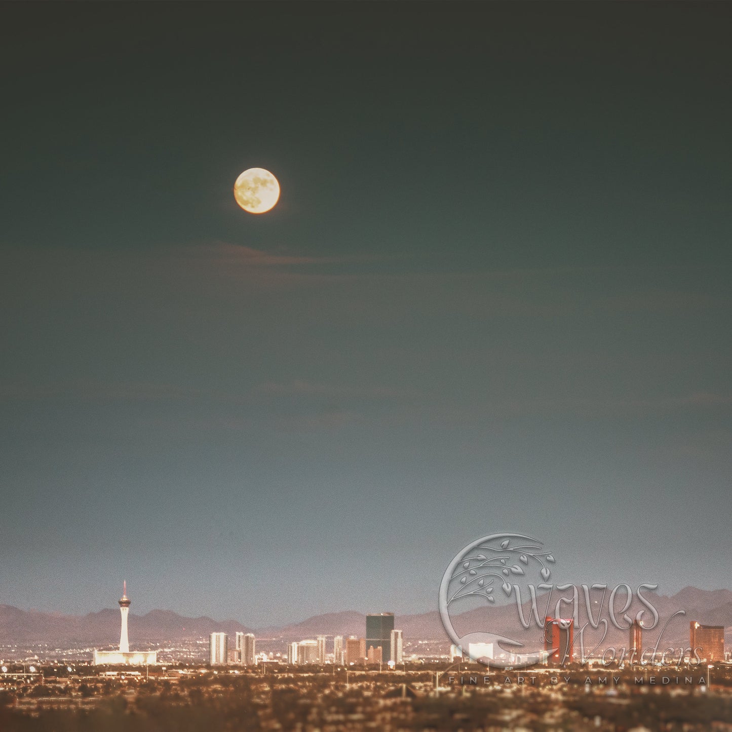 a full moon rises over a city skyline