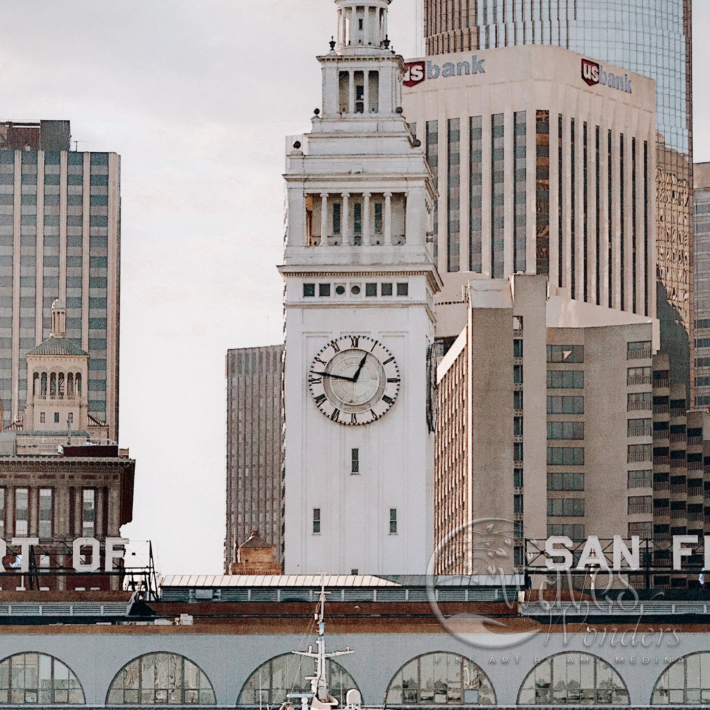 a large white clock tower towering over a city