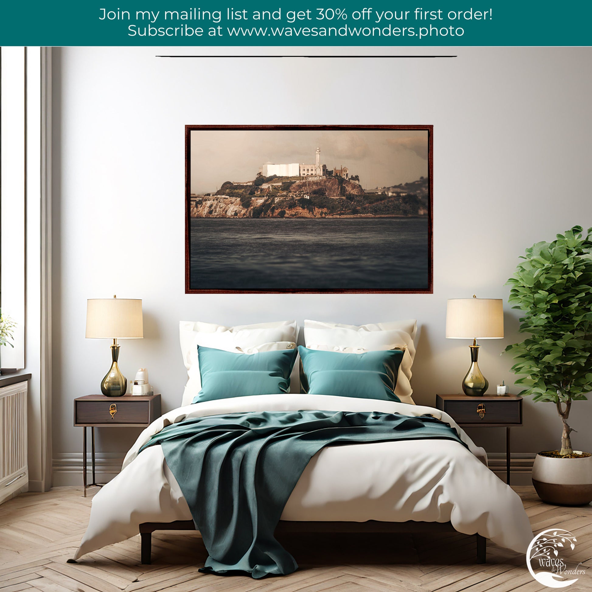 a bedroom with a picture hanging above the bed