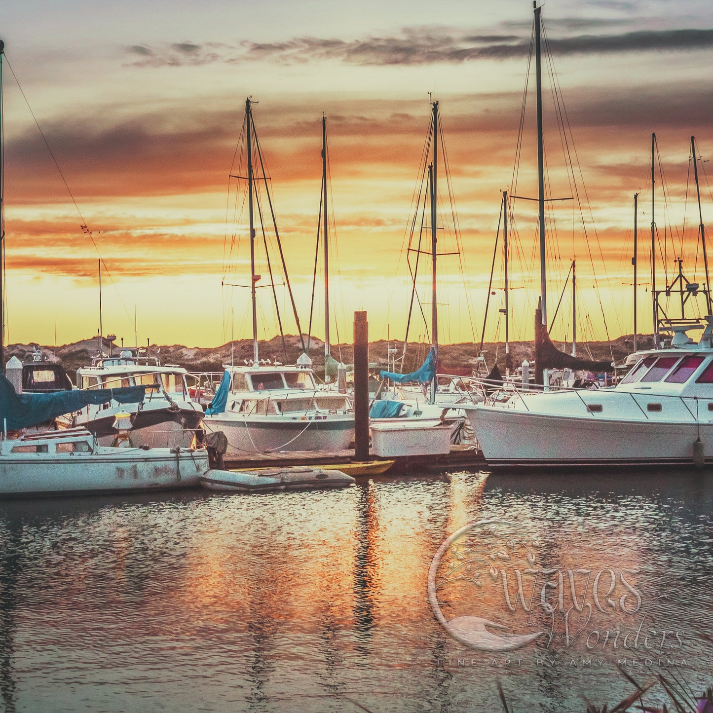 a harbor filled with lots of boats under a cloudy sky