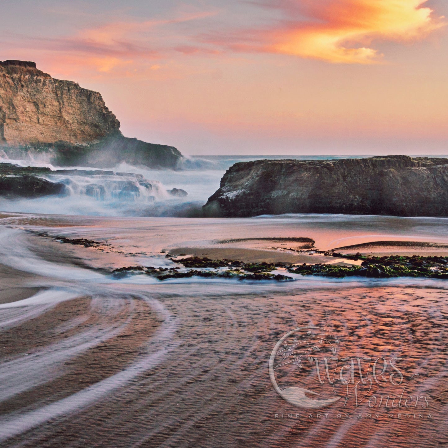 a sandy beach with waves coming in to shore