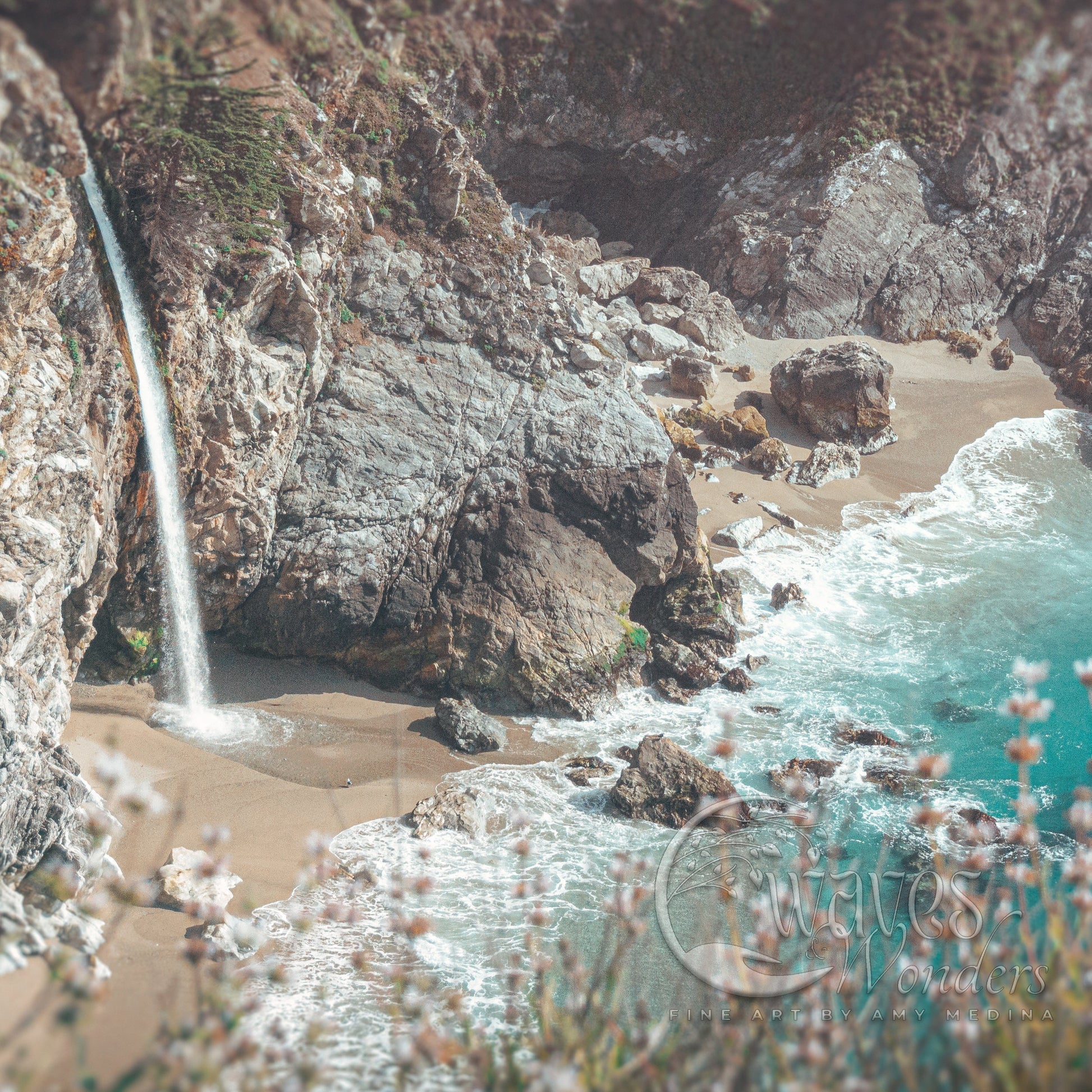 a waterfall is coming out of the rocks into the ocean