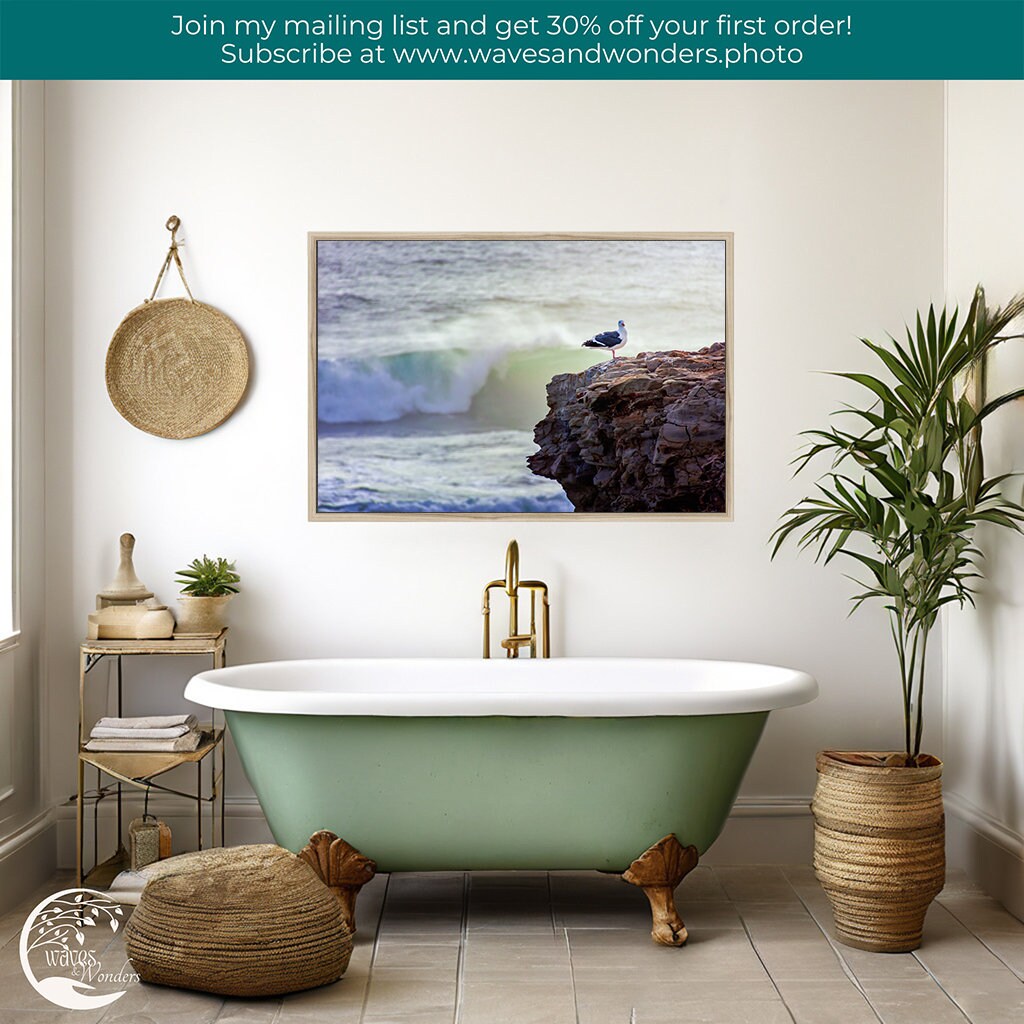 a bathroom with a claw foot tub and a painting on the wall