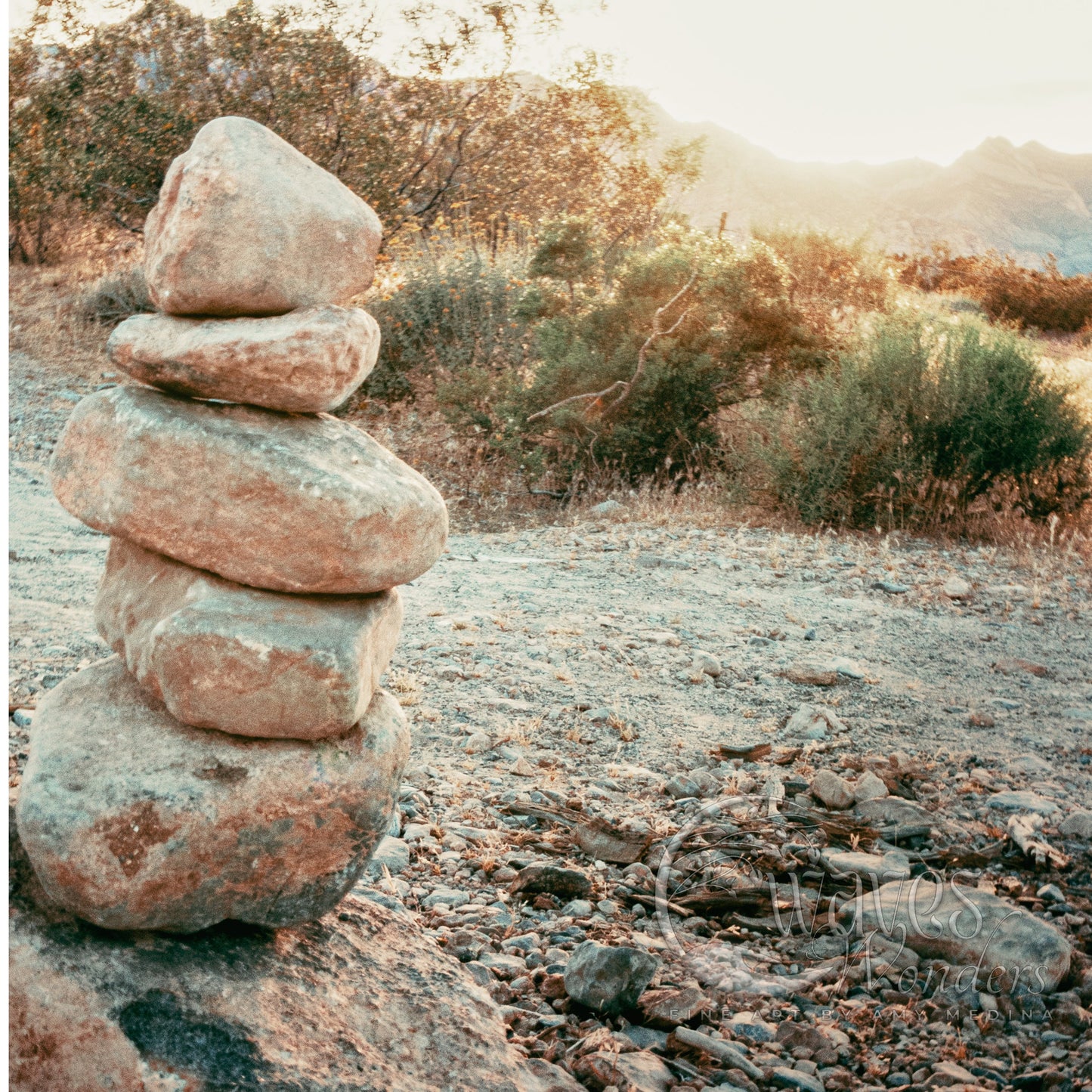 a pile of rocks sitting on top of a dirt field