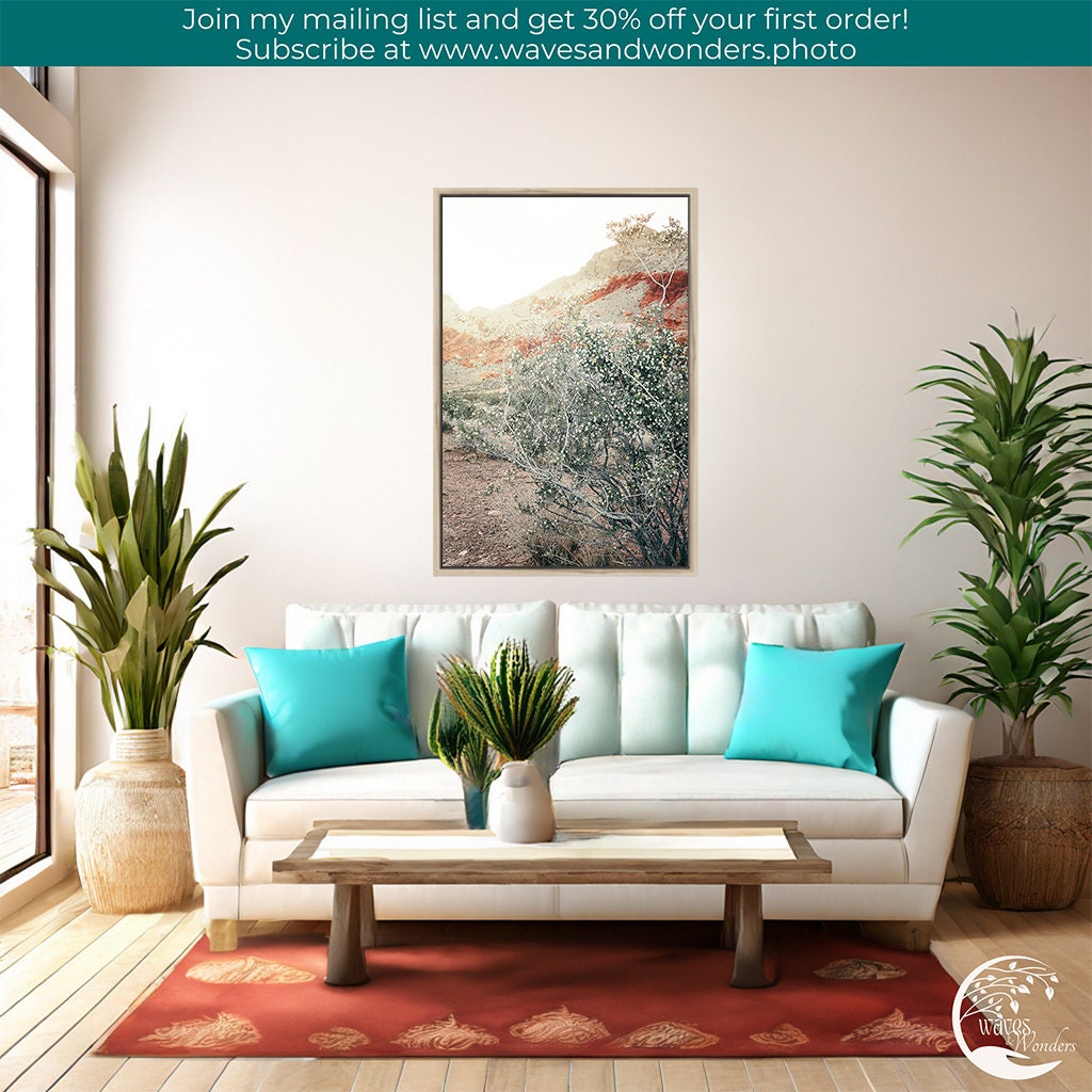 a living room with a couch, table and potted plants