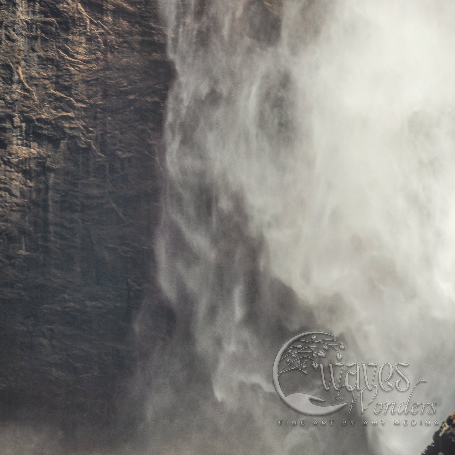 a man standing in front of a waterfall