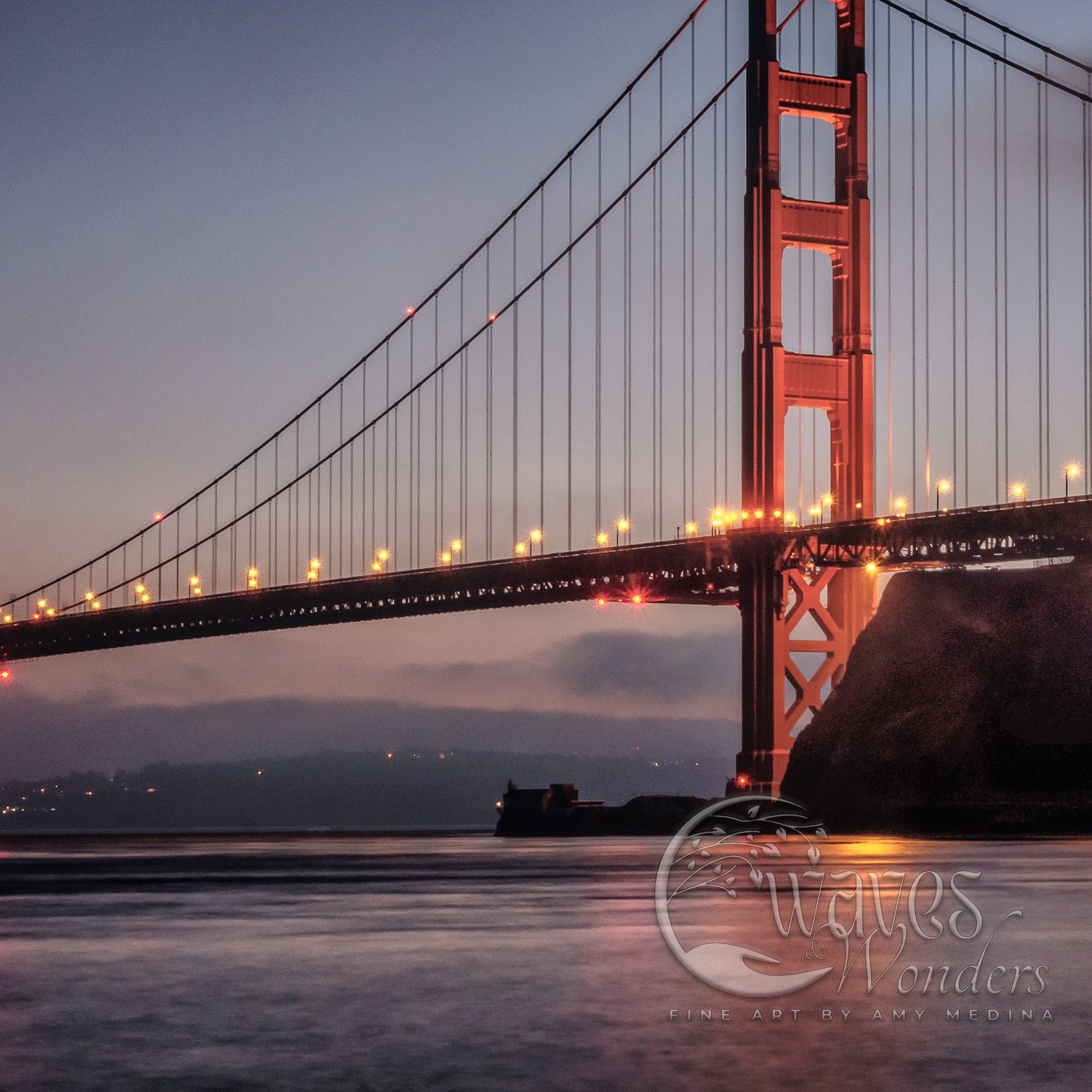 the golden gate bridge is lit up at night