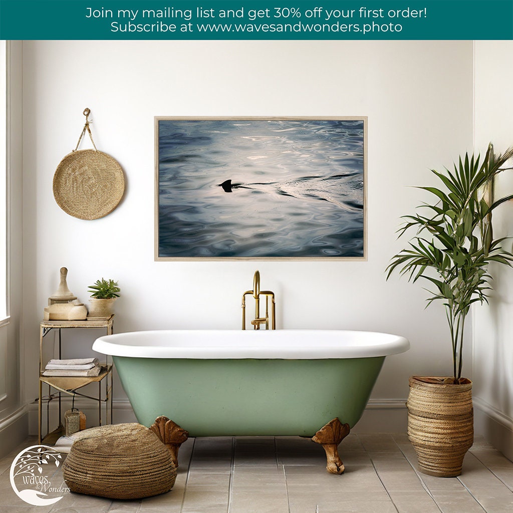 a bathroom with a tub and a painting on the wall