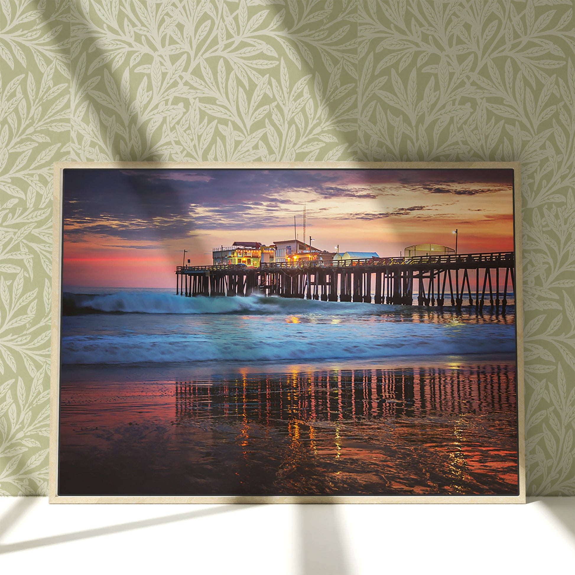 a painting of a pier at sunset on a wall