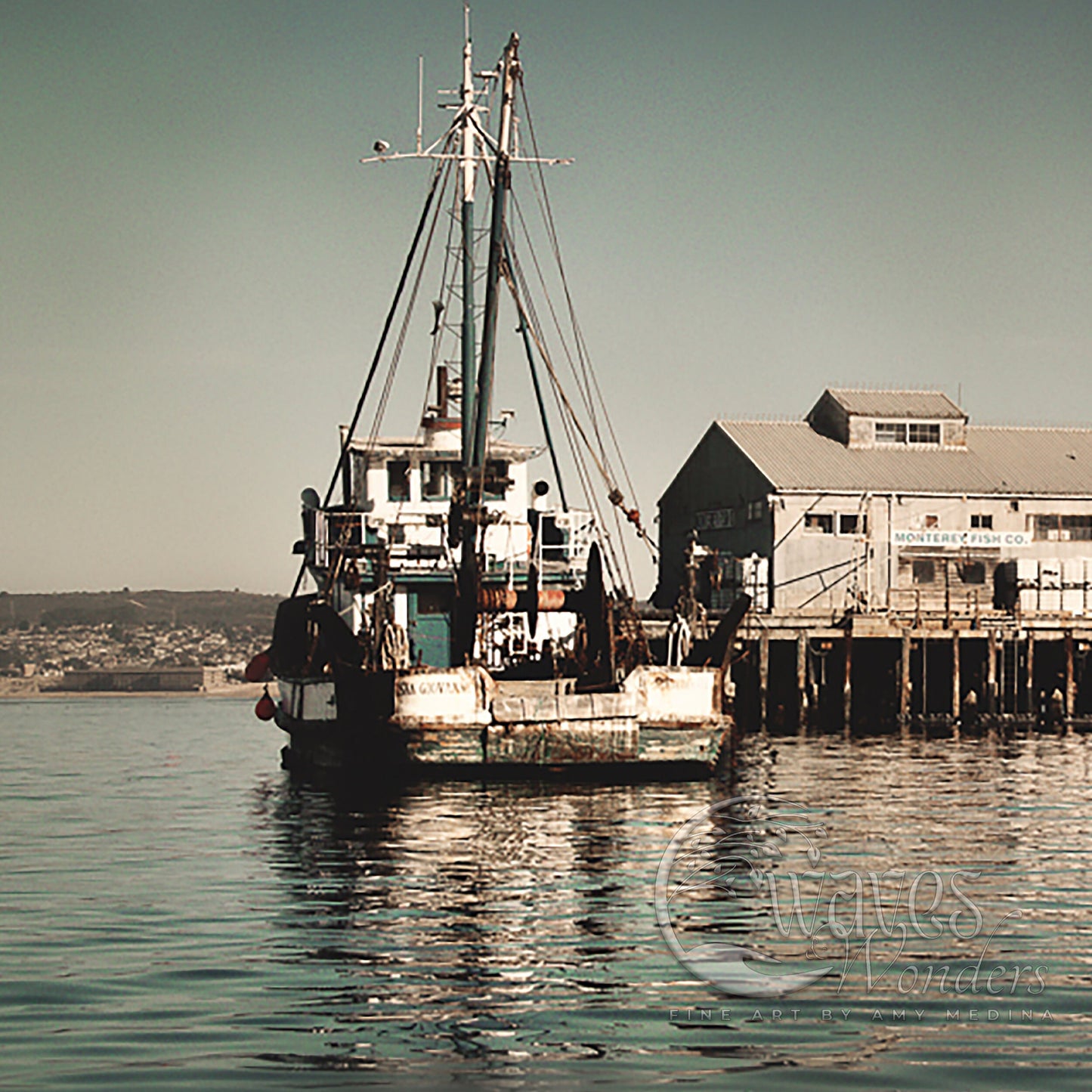 a fishing boat in the water next to a dock