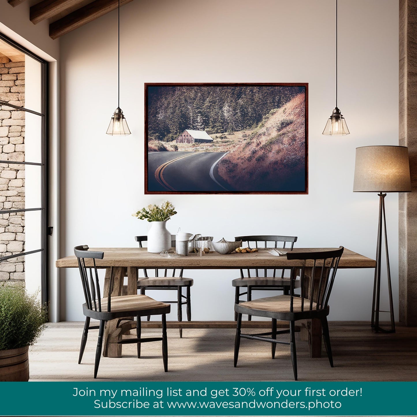 a dining room table with chairs and a picture hanging on the wall