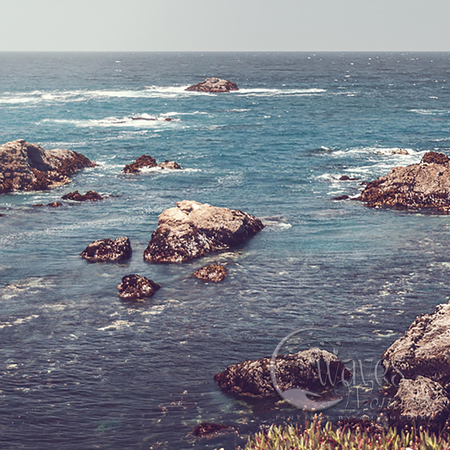 a couple of rocks sitting on top of a body of water