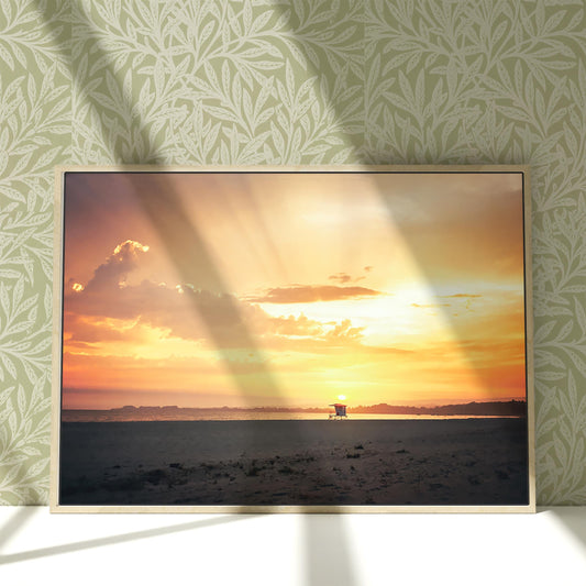 a picture of a person standing on a beach at sunset