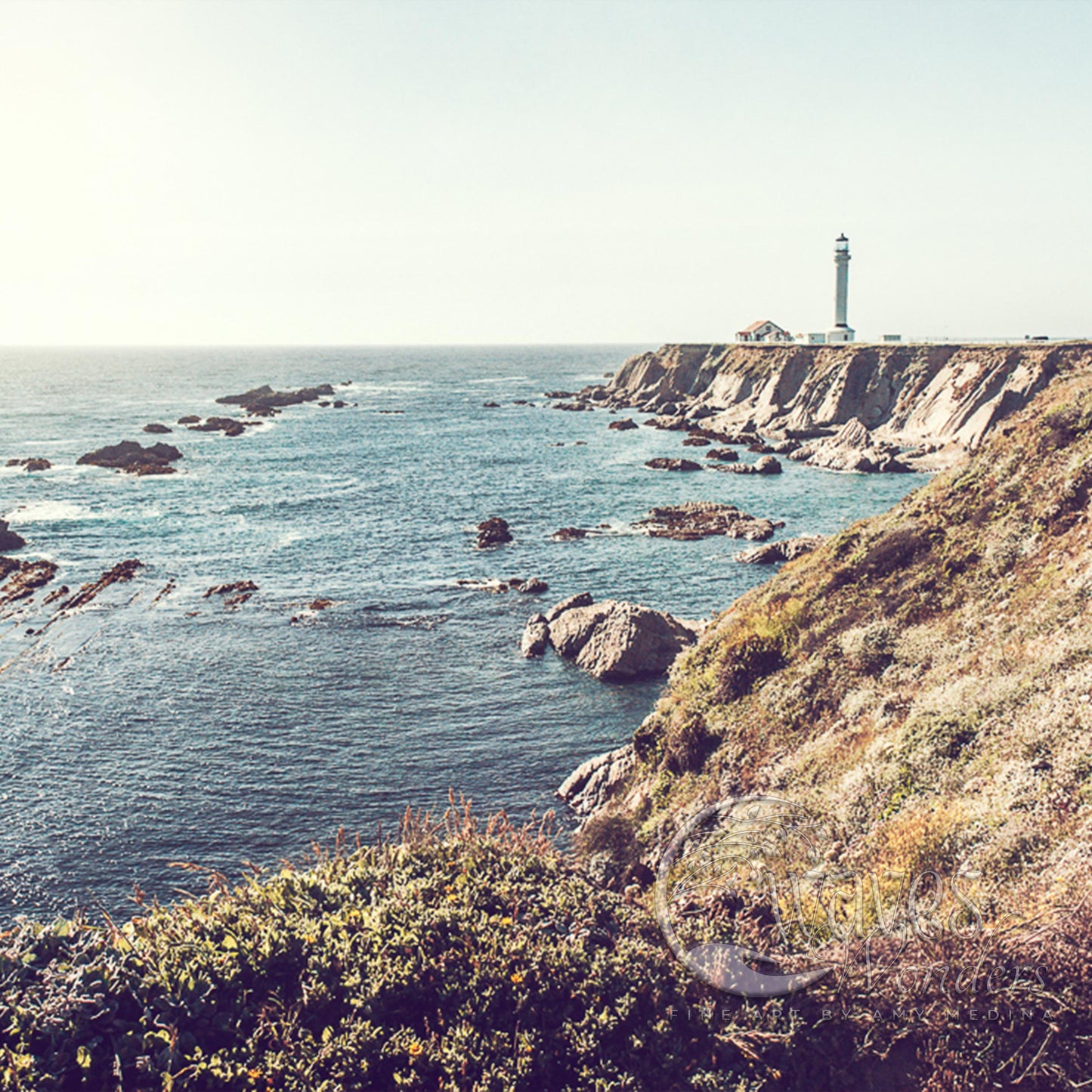 a lighthouse on a cliff overlooking the ocean