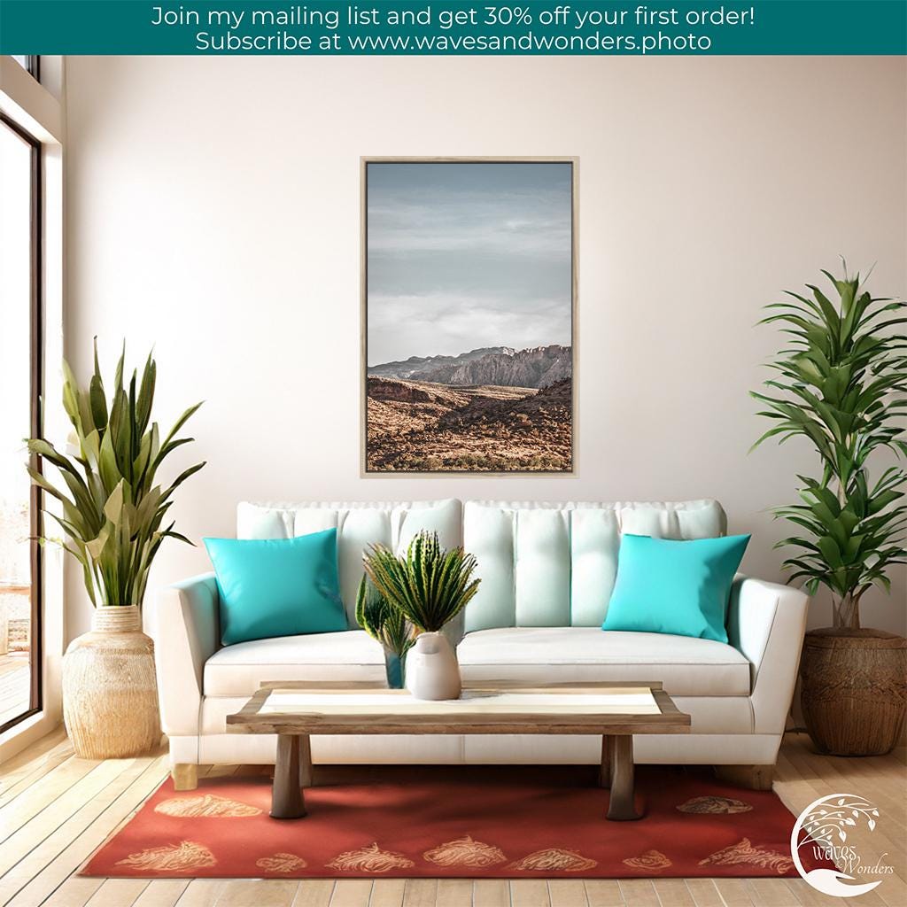 a living room with a couch, table and potted plants