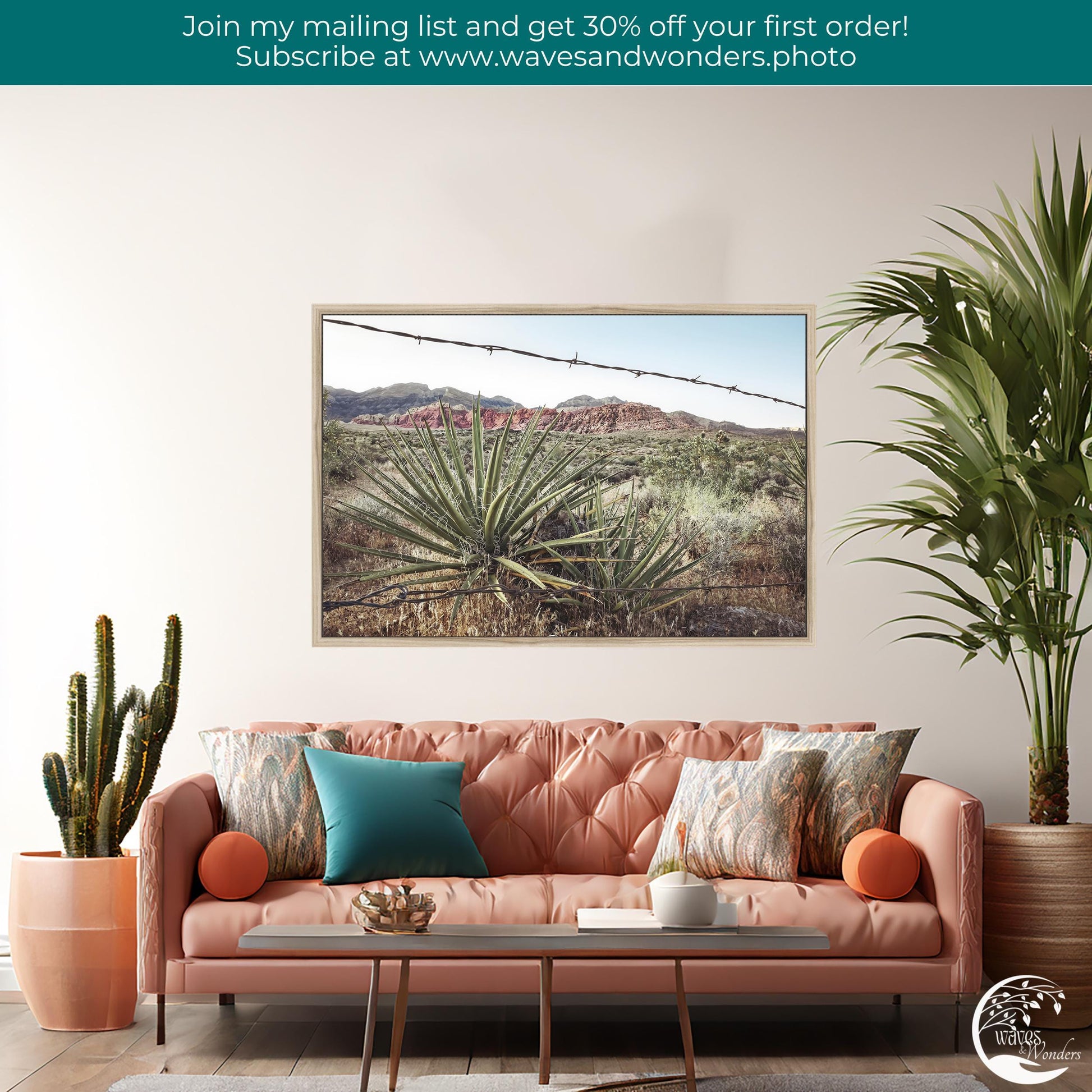 a living room with a pink couch and a painting on the wall