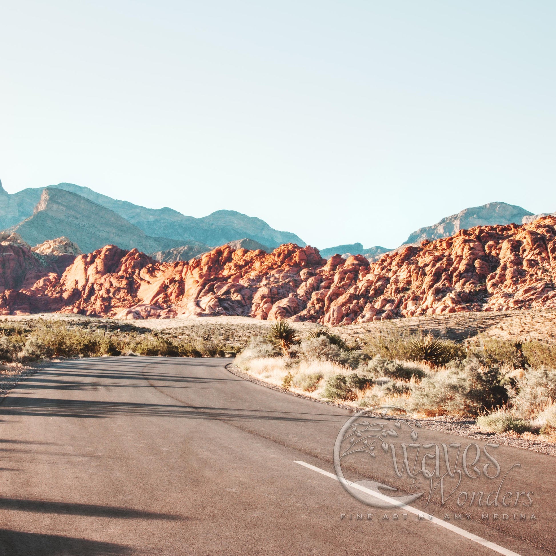 a long road with mountains in the background