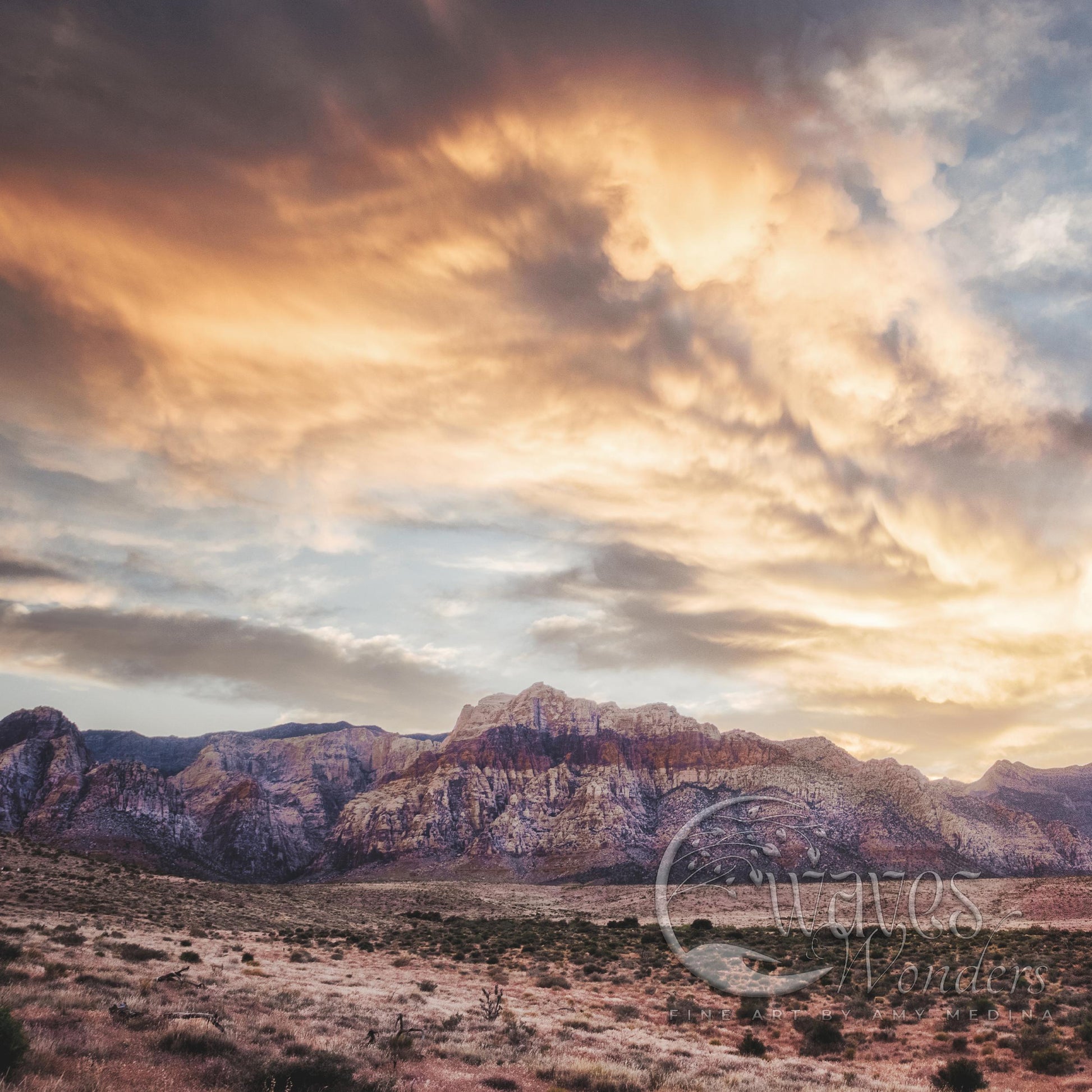 a mountain range with clouds in the sky