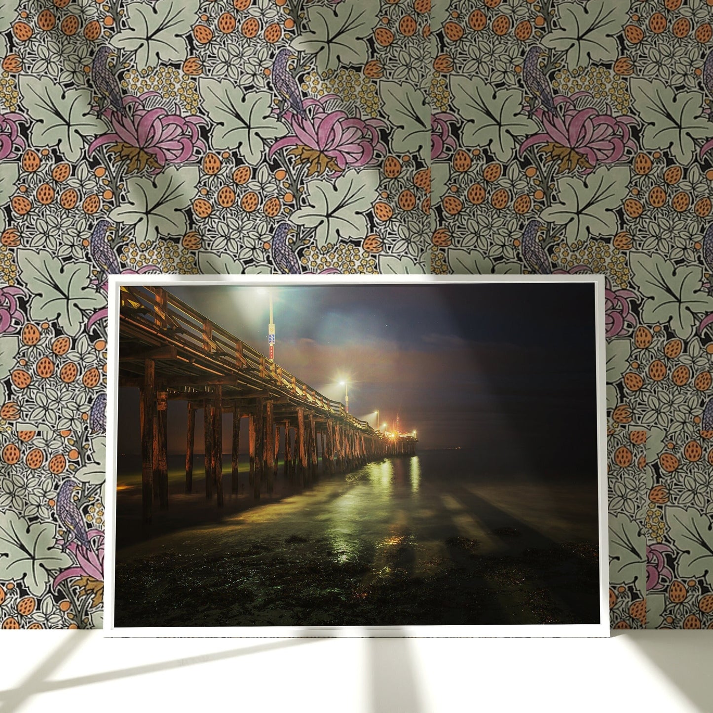 a picture of a pier at night on a wall