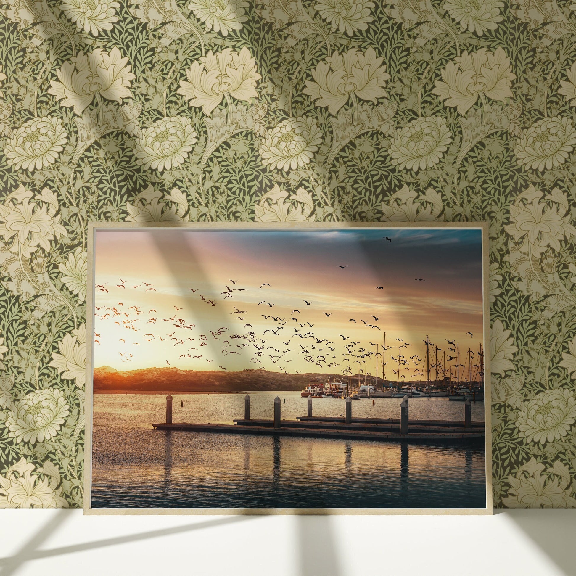 a picture of a pier with birds flying over it