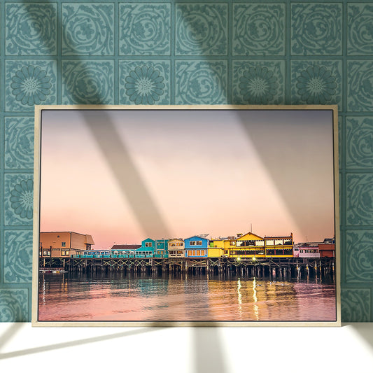 a picture frame hanging on a wall next to a body of water