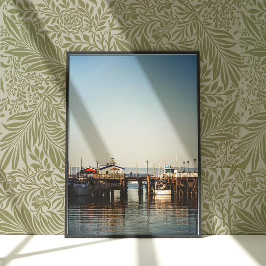 a picture frame hanging on a wall above a body of water