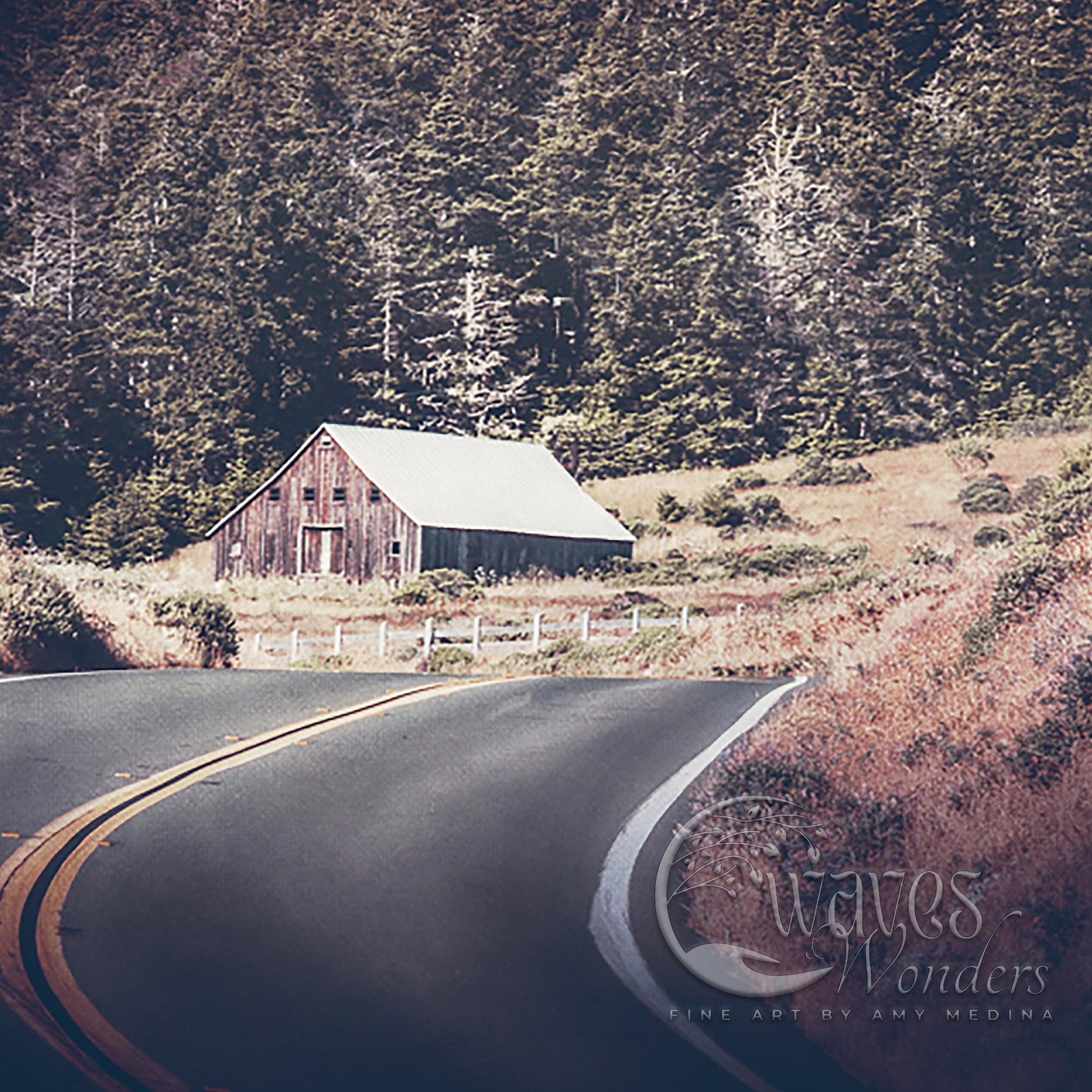 a rural road with a barn in the background